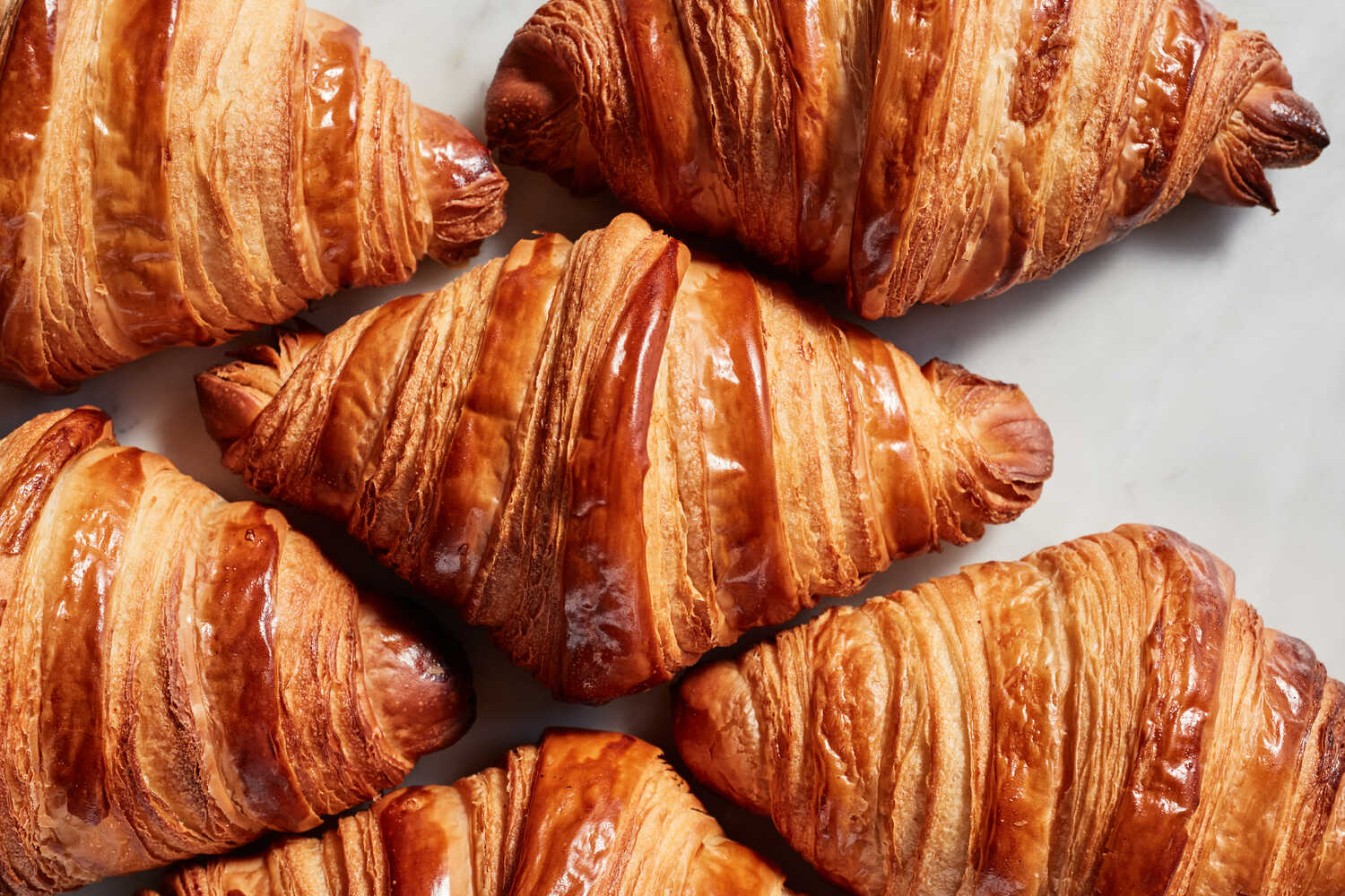 Classic French butter croissant on wooden board